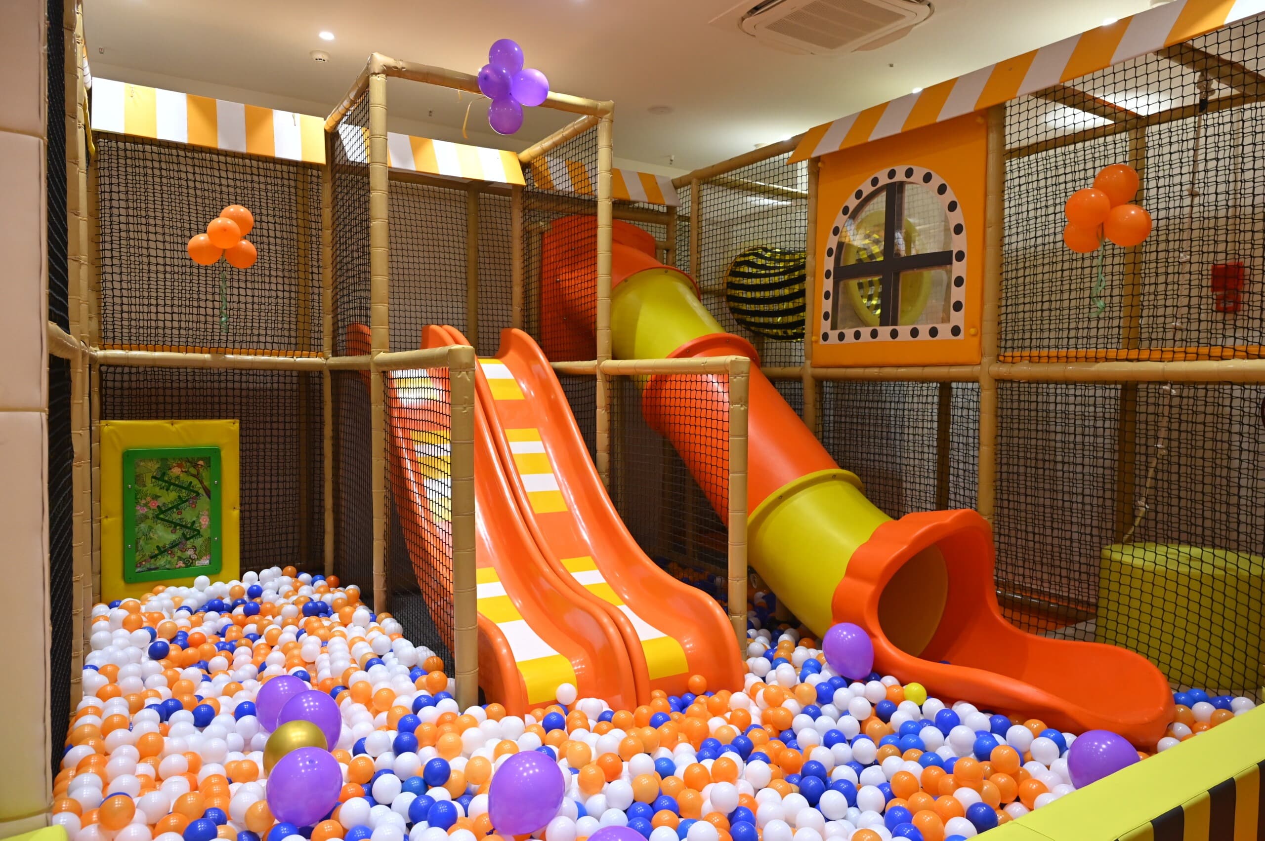 Kids sliding into ball pit